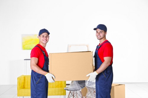 Movers carrying household items from a flat in Acton