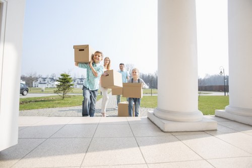Packed boxes and furniture being loaded into a van