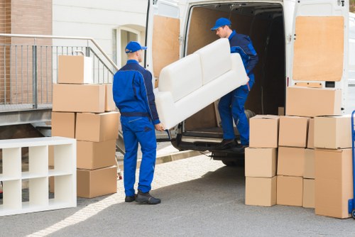 Team handling furniture during a flat move in Acton