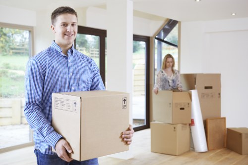 Moving team handling boxes and furniture safely during a van service