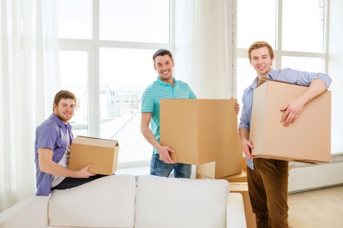 Packed office boxes and equipment ready for business removals in Acton